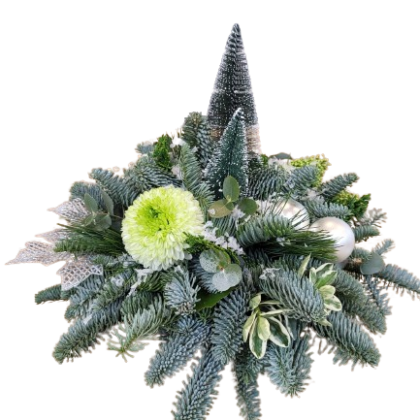 Christmas centerpiece of blue-green pine branches, a frosted cone tree, silver baubles, and a lime green chrysanthemum.
