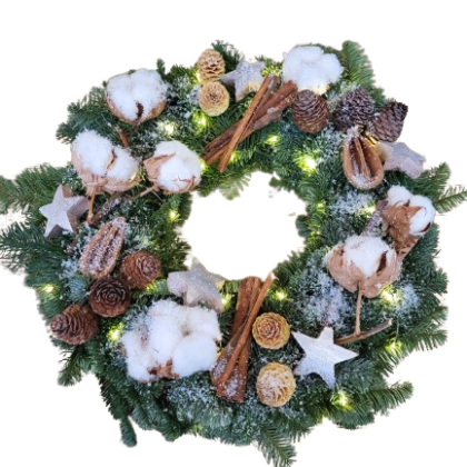 Christmas wreath made of evergreen branches with pinecones, cinnamon sticks, snow, stars and warm lights
