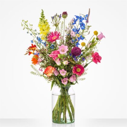 Colorful mixed bouquet in a glass vase on a white background, with pinks, blues, yellows, and greens.