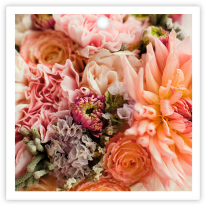 Close-up of a pink and peach bouquet with roses and dahlias.