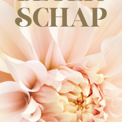 Close-up pale peach flower with the words 'van harte BETER SCHAP' on a greeting card, conveying get-well wishes.